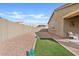 Desert landscaped backyard featuring artificial turf and outdoor seating area at 9910 E Theia Dr, Mesa, AZ 85212