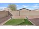 Low maintenance backyard with artificial turf and desert landscape at 9910 E Theia Dr, Mesa, AZ 85212