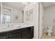 Bathroom featuring a double sink vanity with dark cabinets and wood flooring at 9910 E Theia Dr, Mesa, AZ 85212