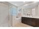 Modern bathroom with separate shower, soaking tub, and dark wood vanity at 9910 E Theia Dr, Mesa, AZ 85212