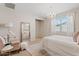 Serene bedroom featuring neutral tones, a decorative chandelier, and bright natural light at 9910 E Theia Dr, Mesa, AZ 85212