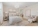 A serene main bedroom features a chandelier, soft color palette, and adjoining bathroom for relaxation and comfort at 9910 E Theia Dr, Mesa, AZ 85212