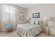 Comfortable bedroom featuring a mirrored accent, neutral tones, and bright natural light at 9910 E Theia Dr, Mesa, AZ 85212
