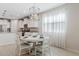 Cozy dining area with a stylish chandelier, white table, and bright natural light at 9910 E Theia Dr, Mesa, AZ 85212