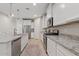 Bright kitchen featuring stainless appliances, granite countertops, and white cabinets at 9910 E Theia Dr, Mesa, AZ 85212