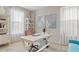 Bright home office with white desk, plush seating, and ample natural light provides a comfortable and productive workspace at 9910 E Theia Dr, Mesa, AZ 85212