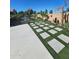 Serene backyard showcasing artificial turf, square pavers, and desert landscaping for low-maintenance appeal at 114 N 119Th Dr, Avondale, AZ 85323