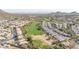 Elevated aerial view of homes alongside a golf course, highlighting the desert landscape and luxurious community setting at 1240 E Friess Dr, Phoenix, AZ 85022