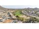 Wide aerial view of a golf course community nestled in the desert hills, showcasing homes with sprawling green fairways at 1240 E Friess Dr, Phoenix, AZ 85022