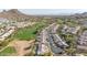 High-angle aerial view of a golf community, showcasing well-appointed homes with desert landscaping and lush green fairways at 1240 E Friess Dr, Phoenix, AZ 85022