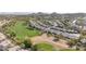 Elevated aerial view of a residential area bordering a golf course, featuring well-kept homes with a desert backdrop at 1240 E Friess Dr, Phoenix, AZ 85022