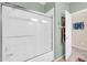 Bathroom with a white shower-tub combo and a sliding glass door at 1240 E Friess Dr, Phoenix, AZ 85022