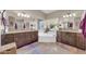 Bright bathroom featuring dual vanities, soaking tub with garden view, and neutral tiling at 1240 E Friess Dr, Phoenix, AZ 85022