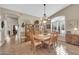 Dining room with wood table, chairs, china cabinet, chandelier, and a large bright window at 1240 E Friess Dr, Phoenix, AZ 85022