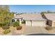 Charming home featuring a landscaped front yard, two-car garage, and a neutral-toned tiled roof at 1240 E Friess Dr, Phoenix, AZ 85022