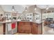 Kitchen island with granite counters, stainless steel sink, and view of living area at 1240 E Friess Dr, Phoenix, AZ 85022