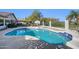 Sparkling backyard pool with basketball hoop and tiled trim, surrounded by lush landscaping and secure fencing at 1240 E Friess Dr, Phoenix, AZ 85022