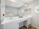 Bright bathroom featuring double sinks, granite countertops, decorative mirrors, and a clear glass walk-in shower at 1244 E Princeton Ave, Gilbert, AZ 85234