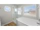 A bright bathroom boasting a large clear glass shower, a tub, and a window showcasing a private outdoor view at 1244 E Princeton Ave, Gilbert, AZ 85234