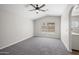 A bright bedroom featuring a modern ceiling fan and neutral gray walls and carpet for a calming aesthetic at 1244 E Princeton Ave, Gilbert, AZ 85234