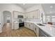 Well-lit kitchen with white cabinets, white countertops, stainless steel appliances, and wood-look floors at 1244 E Princeton Ave, Gilbert, AZ 85234