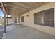 Covered patio area with concrete flooring and access to the backyard, great for outdoor entertaining at 1244 E Princeton Ave, Gilbert, AZ 85234