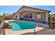 Backyard with a refreshing pool, covered patio, desert landscaping, and ample space for outdoor enjoyment at 12814 W Windrose Dr, El Mirage, AZ 85335