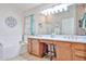 Bright bathroom with double sink vanity, soaking tub, decorative wall art, and a separate glass-enclosed shower at 12814 W Windrose Dr, El Mirage, AZ 85335