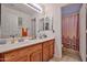 Bright bathroom featuring double sinks, ample counter space, and a separate shower at 12814 W Windrose Dr, El Mirage, AZ 85335