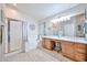 Bright bathroom with double vanity, a full mirror and a shower at 12814 W Windrose Dr, El Mirage, AZ 85335