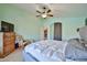 A serene bedroom featuring hardwood floors, a comfortable bed, and a calming color palette for restful nights at 12814 W Windrose Dr, El Mirage, AZ 85335