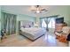 Relaxing bedroom featuring soft lighting, hardwood floors, and neutral color scheme for a peaceful ambiance at 12814 W Windrose Dr, El Mirage, AZ 85335