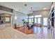 Bright dining area featuring hardwood floors, vaulted ceiling, large windows, and a cozy table setting at 12814 W Windrose Dr, El Mirage, AZ 85335