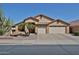 Inviting single-story home featuring a three-car garage and desert landscaping with a mature cactus and palm trees at 12814 W Windrose Dr, El Mirage, AZ 85335