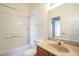 Bright bathroom featuring a shower-tub combo, vanity with sink, and a large mirror at 1331 W Baseline Rd # 340, Mesa, AZ 85202