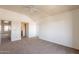 Large bedroom featuring neutral carpet, ceiling fan, and bathroom entrance at 1331 W Baseline Rd # 340, Mesa, AZ 85202