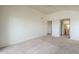 Spacious carpeted bedroom featuring a ceiling fan, ensuite bathroom, and multiple doorways at 1331 W Baseline Rd # 340, Mesa, AZ 85202