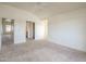 Carpeted bedroom with ceiling fan, multiple entryways, and view into an adjacent living space at 1331 W Baseline Rd # 340, Mesa, AZ 85202