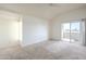 Bright bedroom with plush carpeting, sliding glass doors leading to a balcony, and vaulted ceiling at 1331 W Baseline Rd # 340, Mesa, AZ 85202