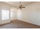 Bright bedroom showcasing carpet, a side window, and a modern ceiling fan at 1331 W Baseline Rd # 340, Mesa, AZ 85202