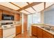 Inviting kitchen with wood cabinets, a breakfast bar, and easy access to the dining area at 1331 W Baseline Rd # 340, Mesa, AZ 85202