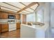 Well-lit kitchen featuring a modern cooktop, ample cabinet space, and a stylish overhead lighting fixture at 1331 W Baseline Rd # 340, Mesa, AZ 85202