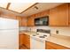 Well-equipped kitchen features wood cabinets, laminate countertops, and modern appliances at 1331 W Baseline Rd # 340, Mesa, AZ 85202