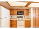 The kitchen boasts wood cabinets, modern appliances, and a unique lighting fixture at 1331 W Baseline Rd # 340, Mesa, AZ 85202
