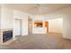 Cozy living room featuring a fireplace, open to the kitchen, with a ceiling fan at 1331 W Baseline Rd # 340, Mesa, AZ 85202
