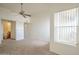 Carpeted main bedroom with ceiling fan, and access to an ensuite bathroom and plenty of natural light at 1331 W Baseline Rd # 340, Mesa, AZ 85202