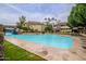 Resort-style pool with waterfall feature, palm trees, and lounge chairs for relaxing at 1331 W Baseline Rd # 340, Mesa, AZ 85202