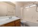 Neat and tidy bathroom with a vanity sink, toilet, and shower-tub combination at 13321 N 124Th Ave, El Mirage, AZ 85335