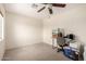 Empty bedroom featuring carpet flooring, a ceiling fan, and a window for natural light at 13321 N 124Th Ave, El Mirage, AZ 85335