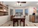 Cozy dining area with tile floors, wooden table, and natural light from windows at 13321 N 124Th Ave, El Mirage, AZ 85335